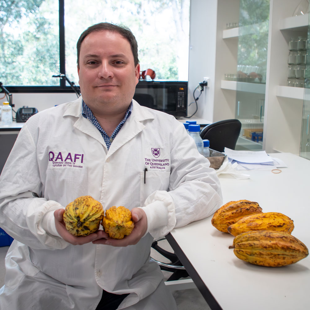 Prof Paul Gauthier sitting in a lab wearing coat and gloves