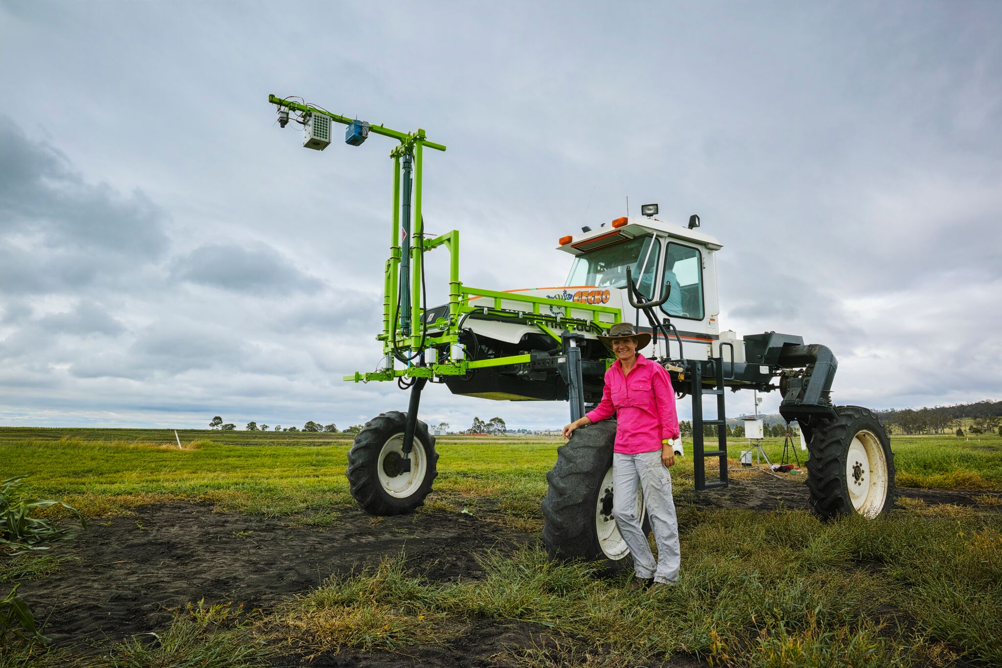Barbara George-Jaeggli standing next to a giant farm machine 