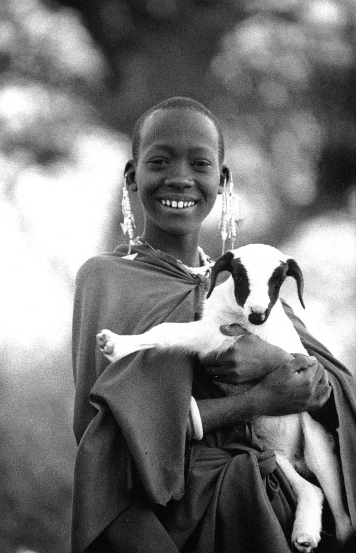 Young African boy holding a goat. Image IRLI
