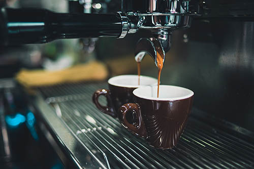 Coffee machine with two cups under it 