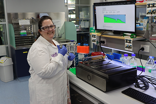 Dr Elizabeth Ross in the lab with the sequencer