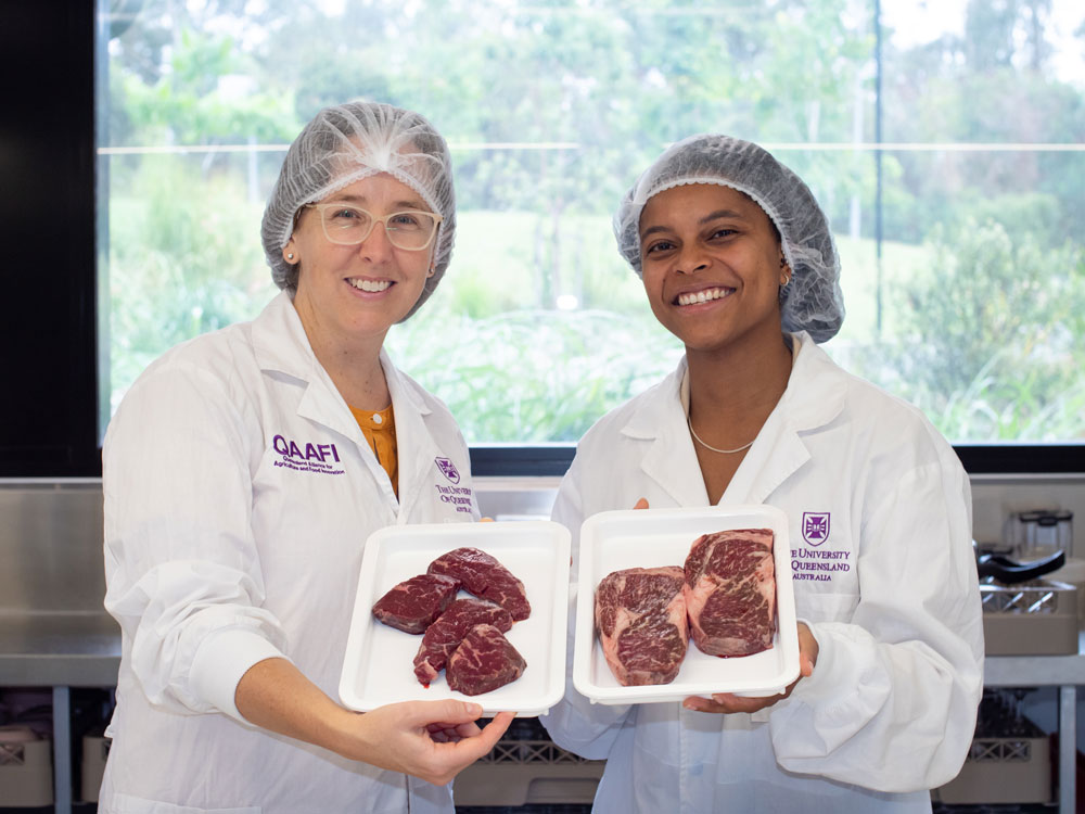 A/Prof Heather Smyth and Dr Raisa Rudge holding a platter of wagyu beef