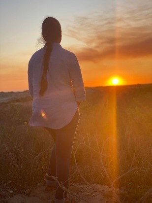 Shot from behind of Sukirtha looking at the setting sun