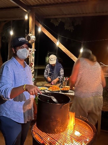 People standing around a fire 