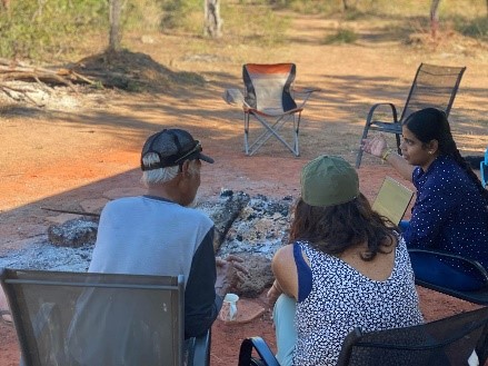 Sukirtha with Bruno and Marion around the fire 