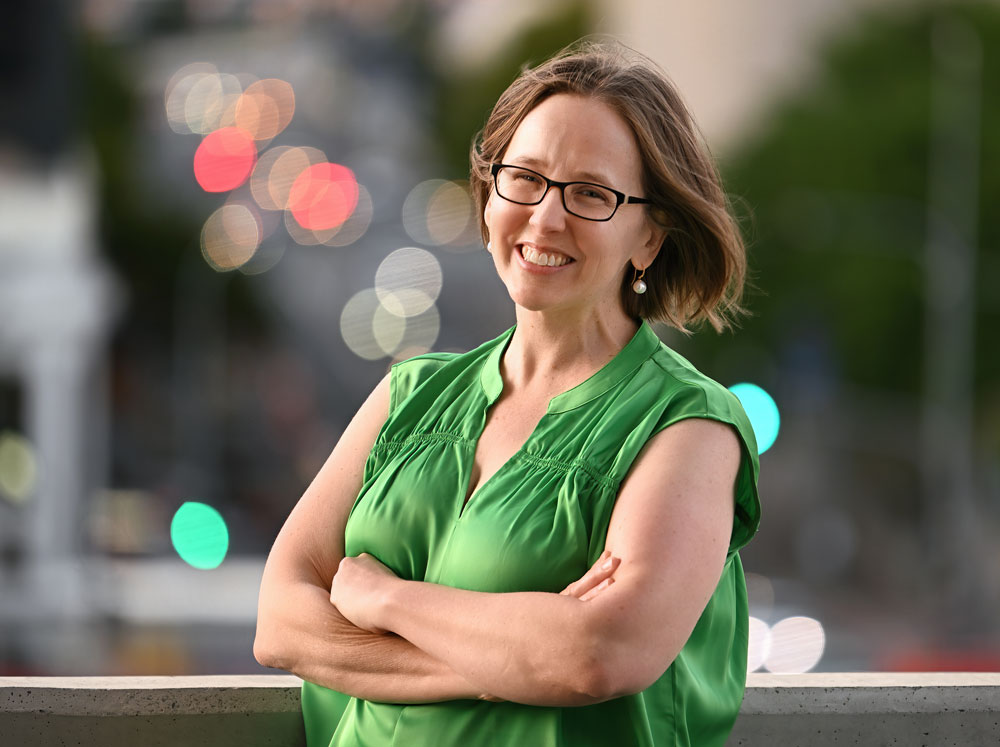 Headshot of Ass Prof Heather Smyth with arms crossed wearing a green blouse