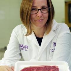 UQ QAAFI A/Prof Heather Smyth holding Westholme Wagyu in the sensory test kitchen.