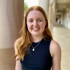 Tori Millsteed in UQ's Great Court with sandstone behind her