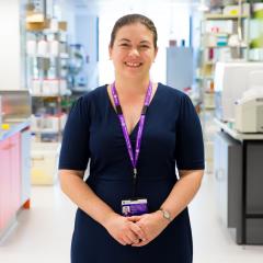 Headshot of Dr Selina Fyfe in a laboratory with arms clasped in front of her 
