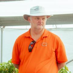 Dr Chris O'Brien standing in a greenhouse in Chile during visit to teach tissue culture protocols