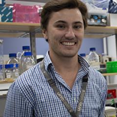 PhD candidate Harrison Lamb headshot in lab setting 