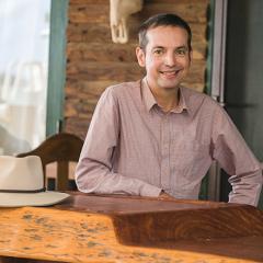 Professor Ben Hayes sitting at a wooden bar