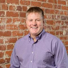 Headshot of Haven Baker against a brick wall 