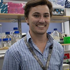 PhD candidate Harrison Lamb headshot in lab setting 
