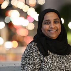Headshot of Prof Yasmina Sultanbawa with blurred city lights behind