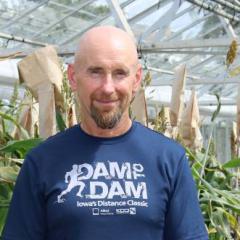 Professor Mark Cooper standing in a greenhouse